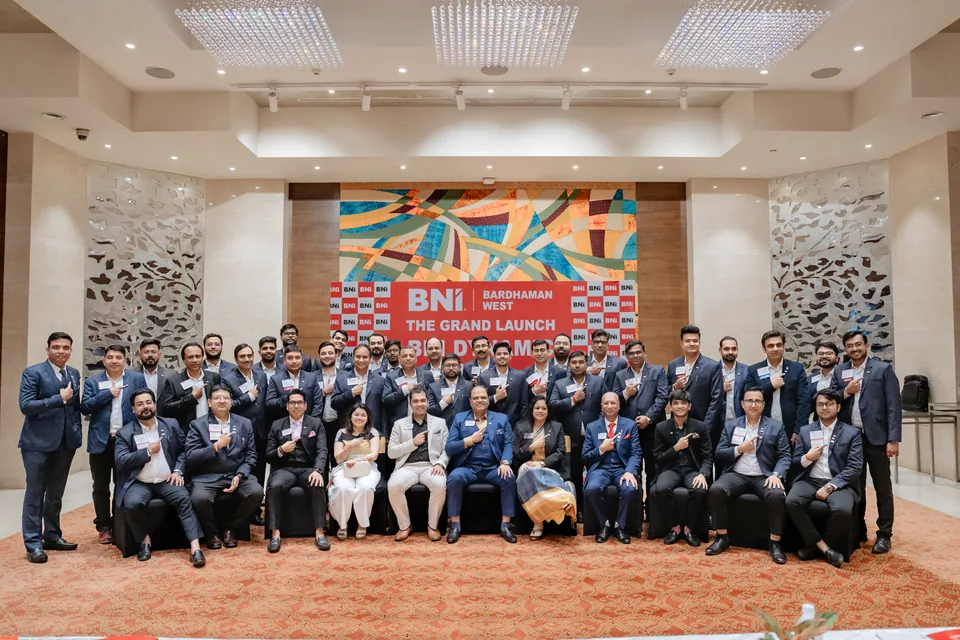 BNI Dynamic participants posing in front of the Bardhaman West grand launch backdrop.