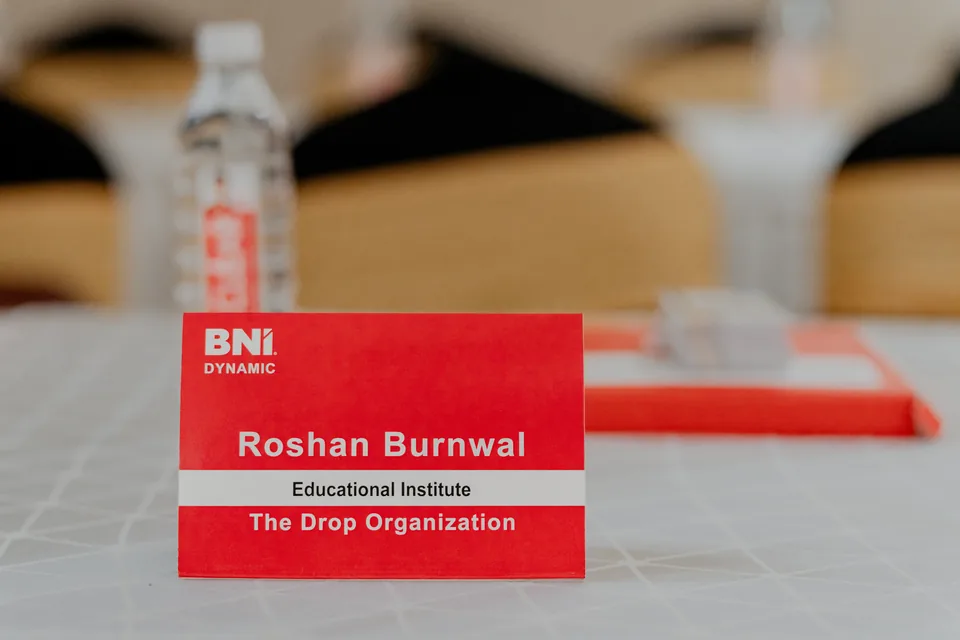 BNI Dynamic table card naming Roshan Burnwal, The Drop Organization and the Educational Institute category.