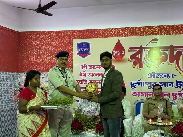 Roshan Burnwal pictured receiving a plaque at a blood donation event in The Drop Organization official gallery.