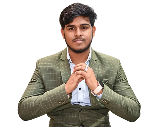 Portrait of Roshan Burnwal wearing a checked suit, with his hands clasped